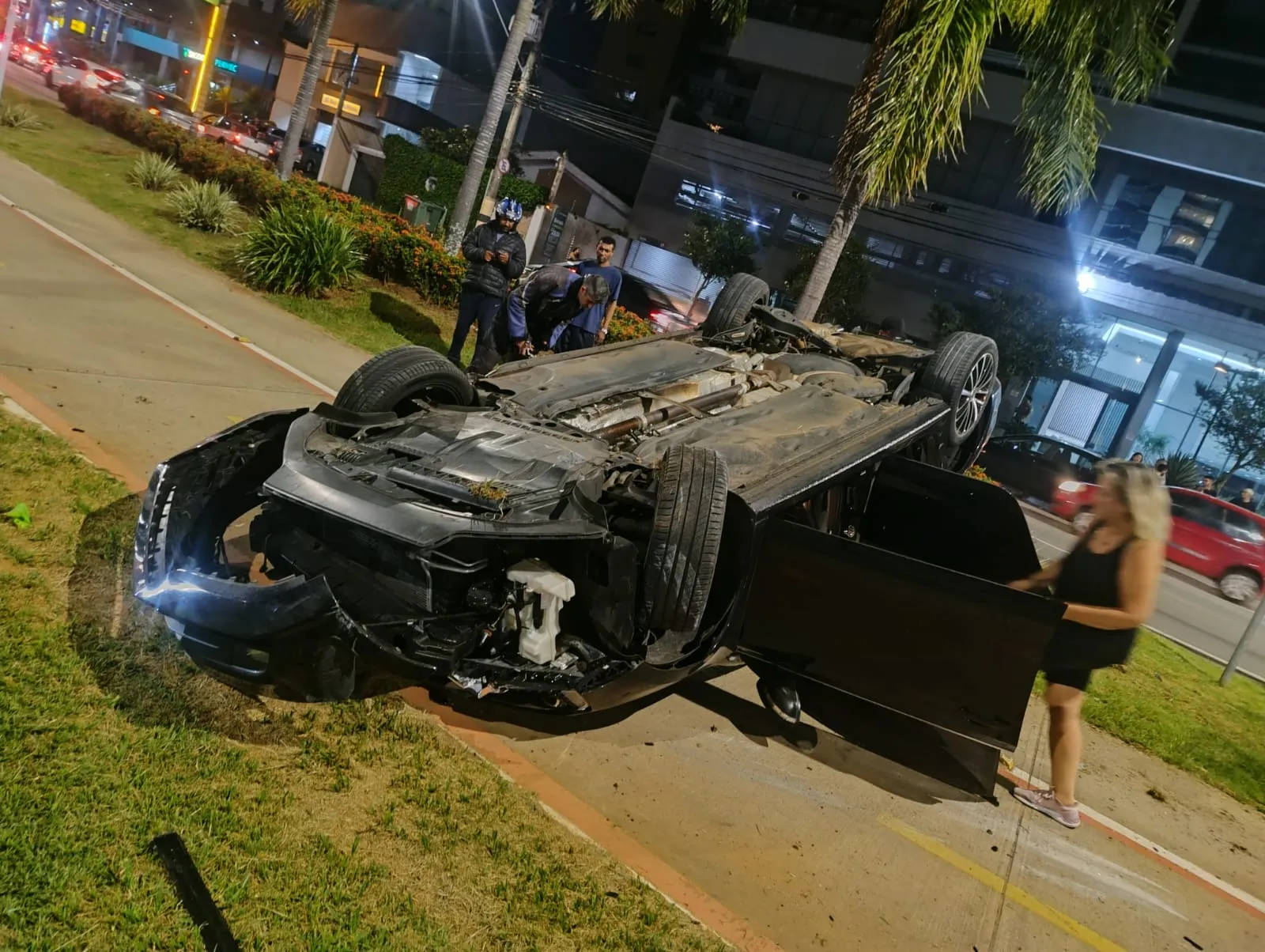 Carro capotado e poste danificado na Avenida Norte-Sul, Campinas, com bombeiros no local.