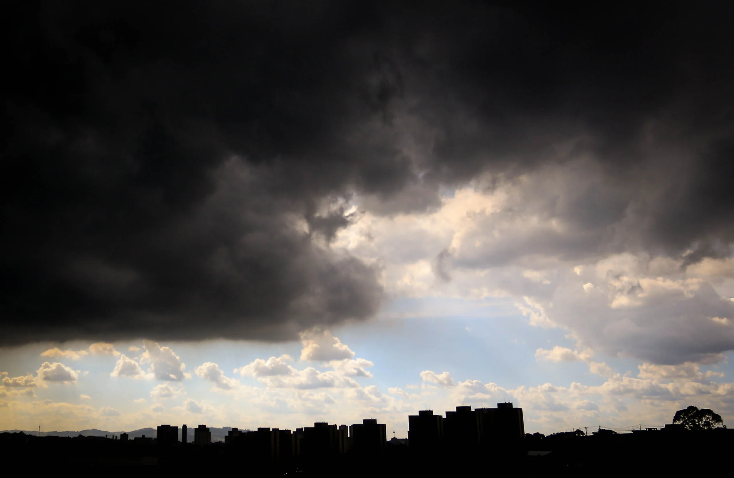 Ruas de São Paulo com acúmulo de água e tráfego prejudicado durante alerta de chuva.