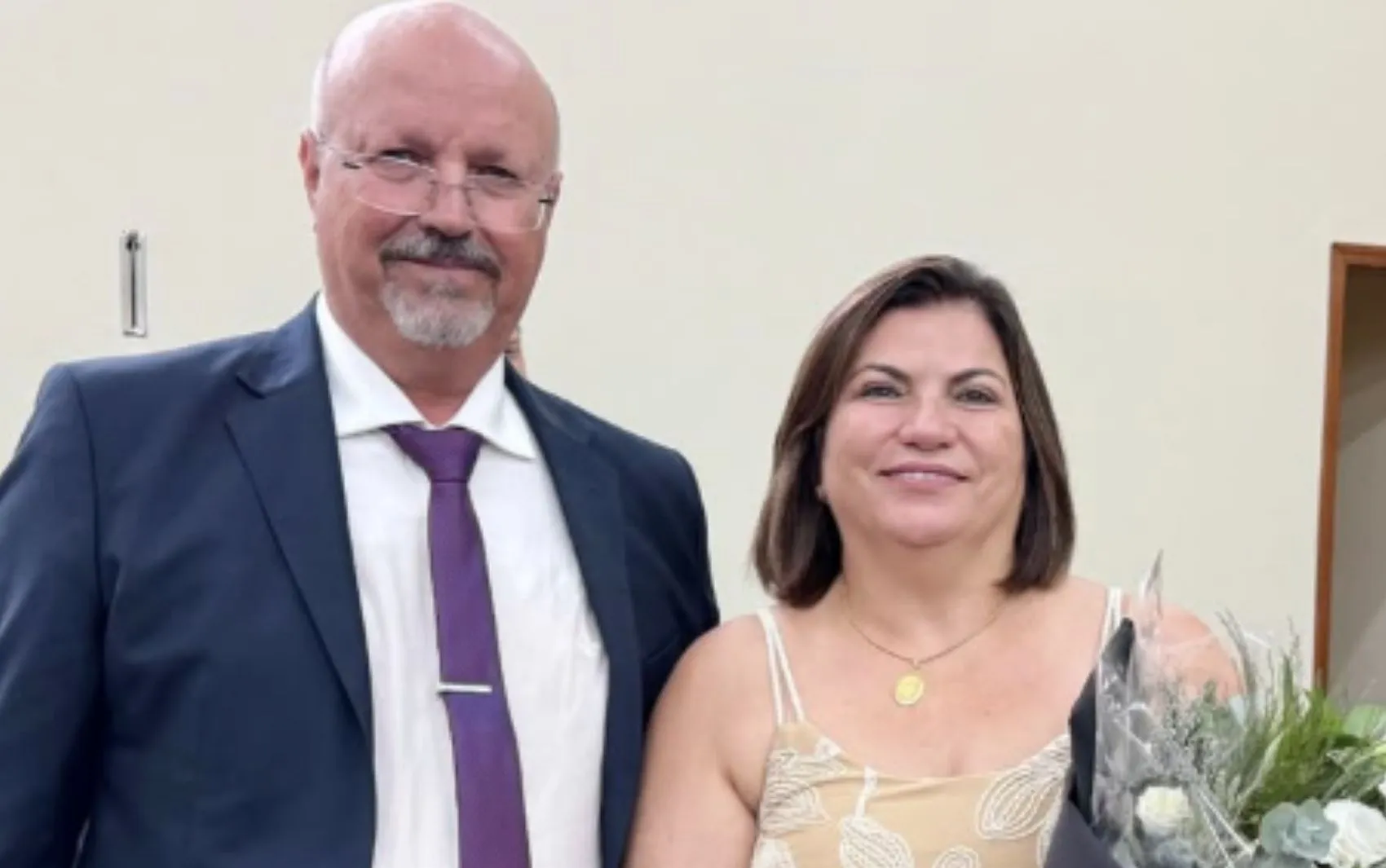 Vista aérea da cidade de Vista Alegre do Alto em luto, com bandeiras a meio mastro e pessoas reunidas para o velório do prefeito e primeira-dama.