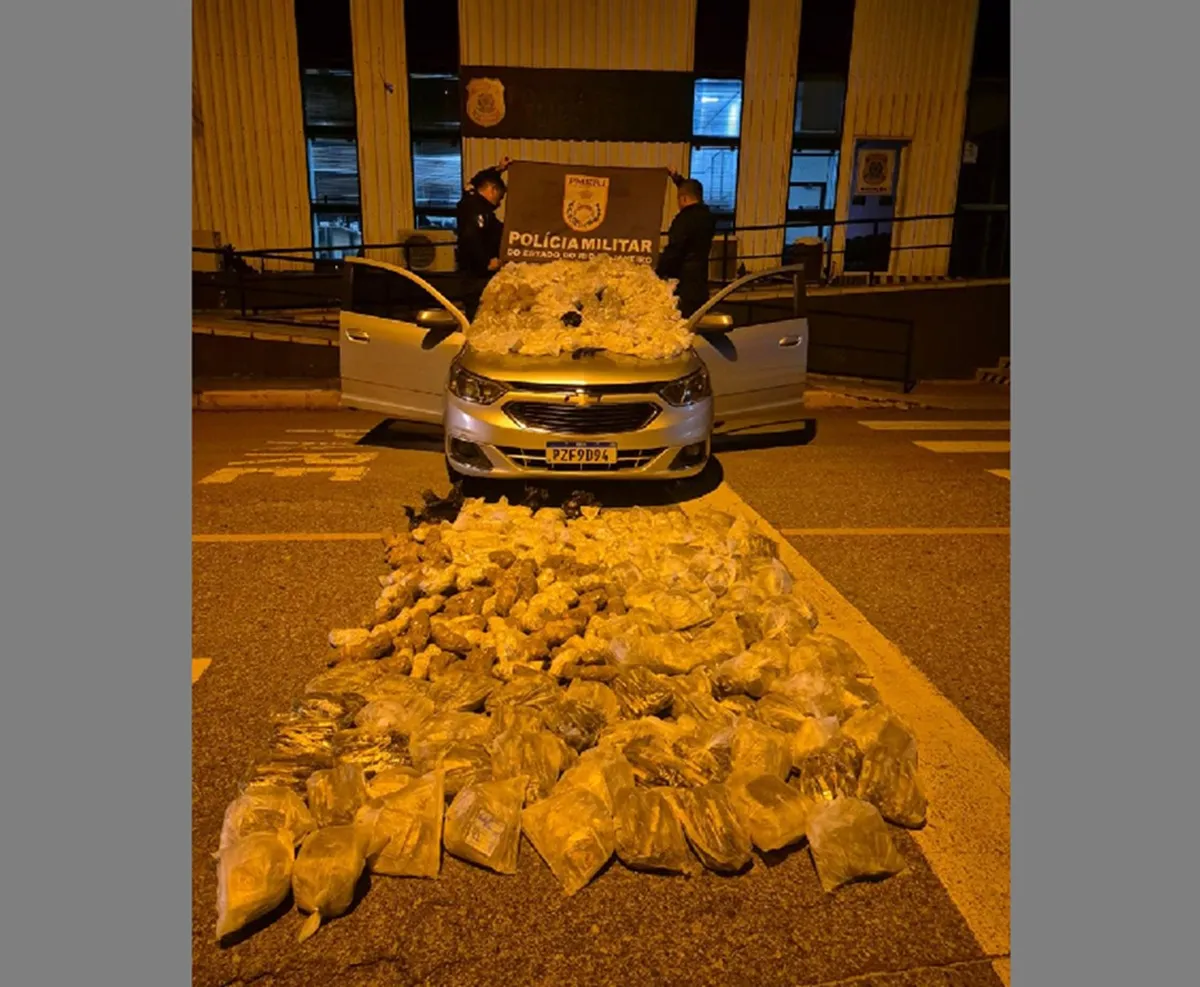 Policiais examinam drogas e revólver apreendidos em carro