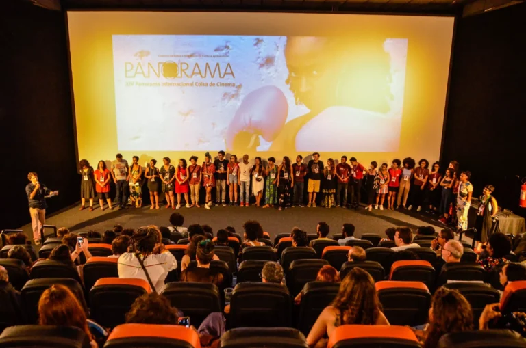Pessoas em festival de cinema na Bahia, assistindo filme