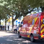 Canaleta de ônibus ligeirinho em Curitiba com pedestre atravessando em segurança