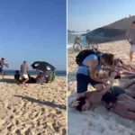 Policiais prendendo olheiro do tráfico Rhamon Santana Gomes na Praia da Macumba