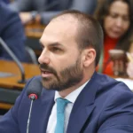 Gavel e documentos legais em mesa de tribunal, representando o processo de Eduardo Bolsonaro no STF