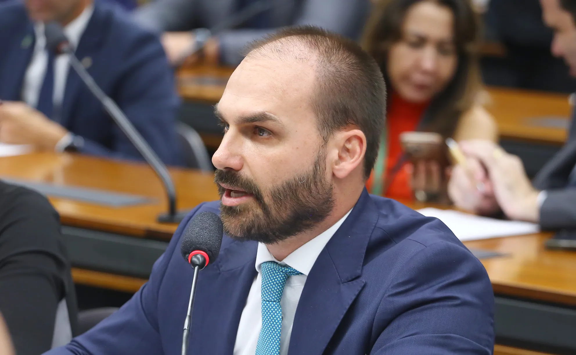 Eduardo Bolsonaro na frente do STF, representando o andamento do processo judicial.