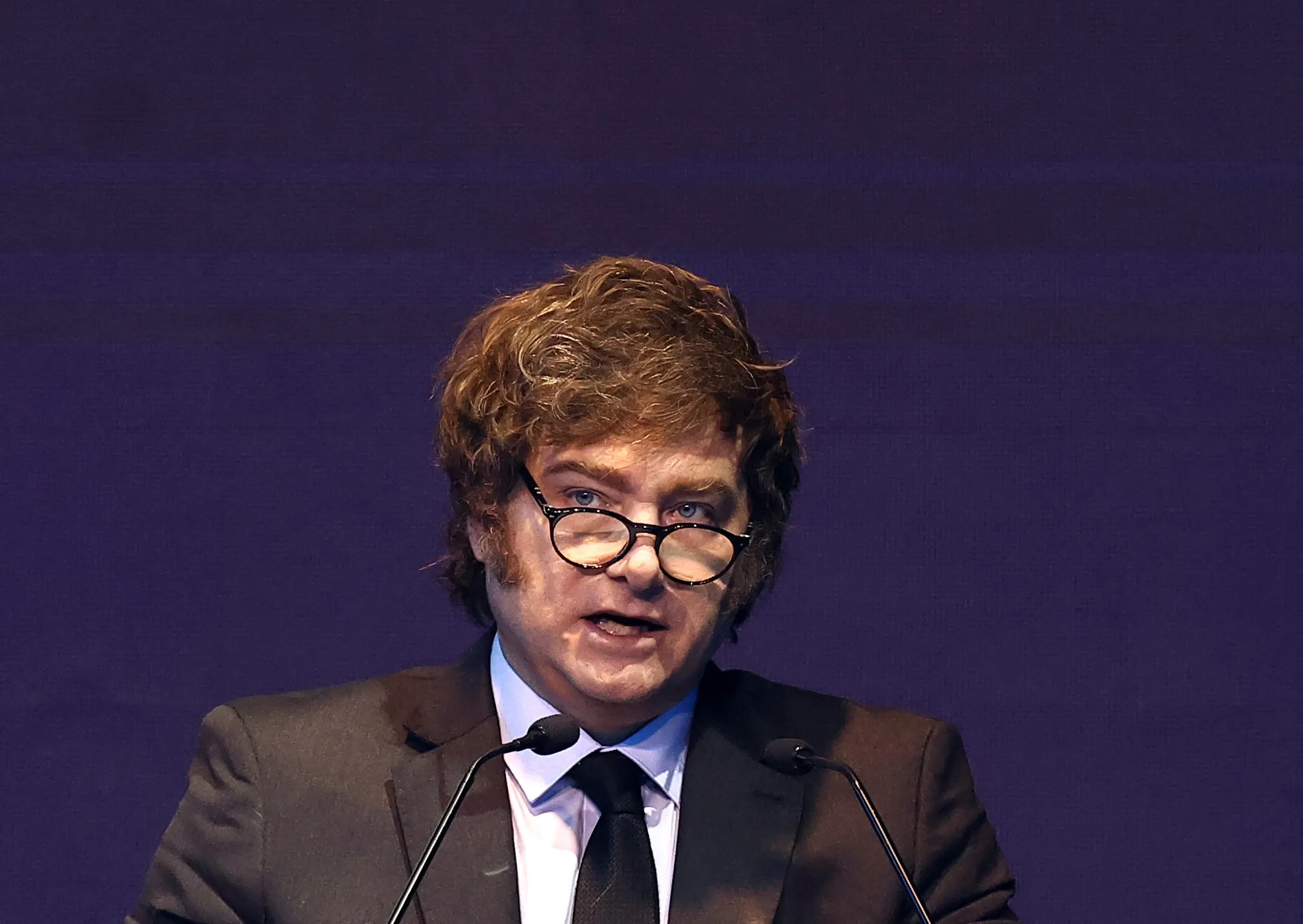 Dinheiro argentino e gráfico de inflação subindo, simbolizando a alta de preços.