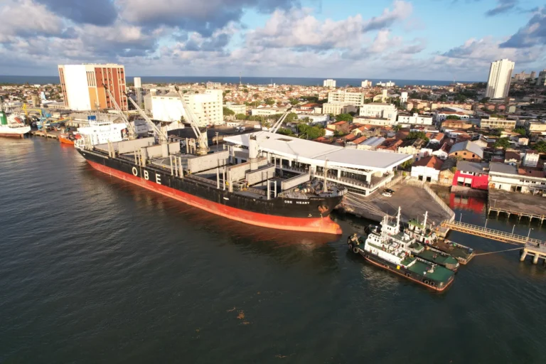 Balança comercial com moedas e produtos, indicando superávit