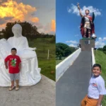 Menino Sérgio Antônio em frente aos santos gigantes no Caminho dos Devotos, interior de São Paulo.