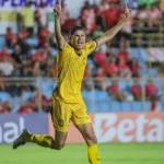 Jogador Erick Varão em uniforme de futebol comemorando, simbolizando sua rescisão de contrato com o Amazonas.
