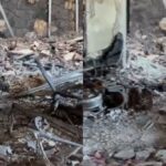 MC Gui em pose pensativa, com leves ferimentos visíveis, ao lado de uma moto elétrica ou em frente a uma casa em reconstrução, simbolizando superação.