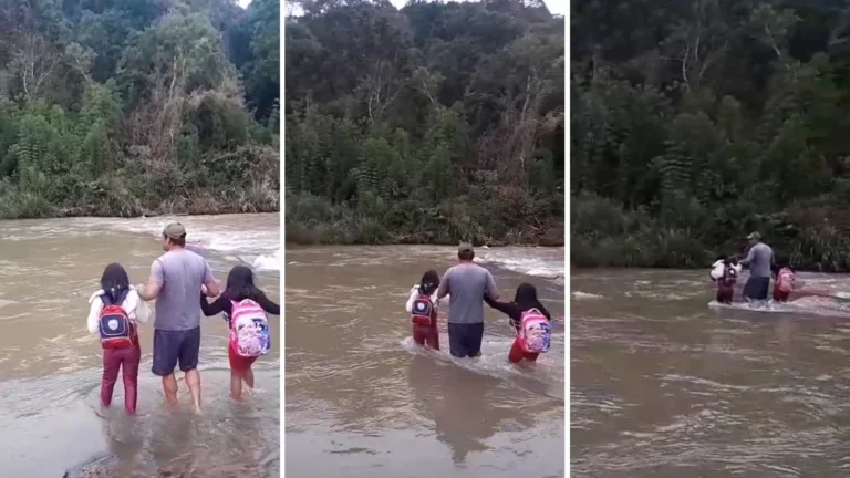 Meninas atravessando rio com mochilas para ir à aula